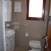 Piccolo bagno con lavabo, bidet e finestra con cornice in legno.
